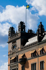 Swedish flag flying above the Swedish Riksdag (parliament) building